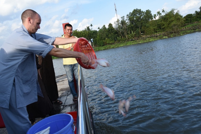 Praying for rebirth and releasing creatures in Ba Lua port, Cu Chi